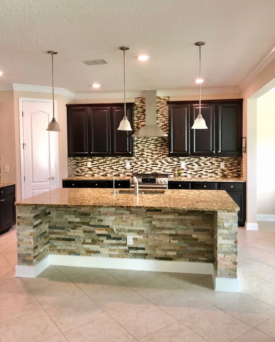 Custom stacked stone island and glass tile backsplash installation in a St. Johns County FL kitchen remodel